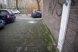 Automobiliste schampt sporthal, rijdt over paal en raakt gewond